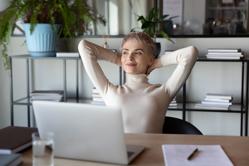 distracted from job happy peaceful blonde businesswoman relaxing in office.